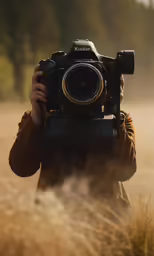 a person holding a camera with a blurry background