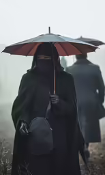 a person with an umbrella and some sort of person with backpack walking through the fog