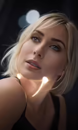an attractive blonde female poses with her light on