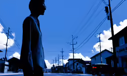 a silhouetted man in the street at an intersection