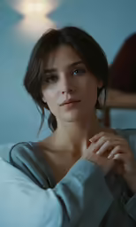 a woman looking to the side with her hand near her chin