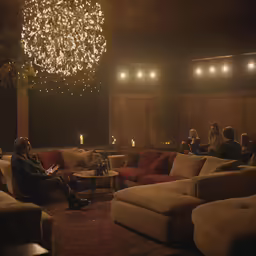 several people are gathered in a dimly lit room