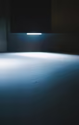 an empty room with two square lights shining in the middle