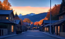 a street filled with small houses on either side of a mountain range