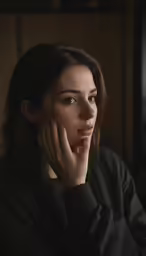 a young woman is sitting in a chair