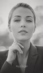 a woman with an elegant looking face and black jacket