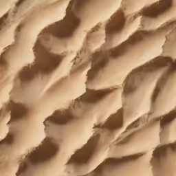 abstract patterns are shown in the sand that has been made into a wall