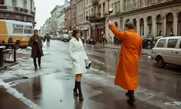 a woman with an orange trench coat taking a photo on her phone