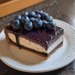 a piece of cake on a plate with blueberries