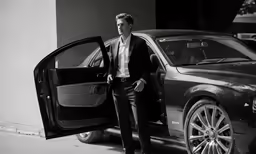 a man that is standing next to a car