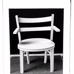 black and white photo of a white chair with backrest
