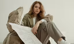 the model is posing on a pile of rock