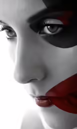 a beautiful woman wearing a mask and makeup