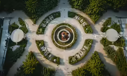 an aerial view of a circular garden and surrounding trees