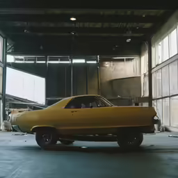 a car sits in a garage in front of windows