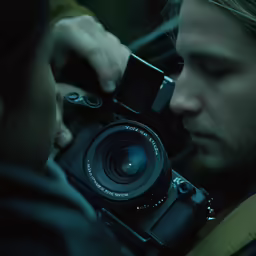 a man is taking a photo of another man