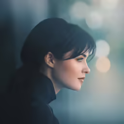 a woman in black is staring to her right