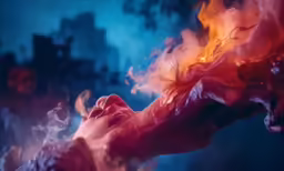 a woman with her eyes open and hands folded over her face as flame approaches