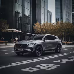 grey volvo suv driving down an urban street