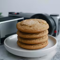 a plate topped with cookies and a camera
