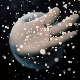 hand in water, with bubbles and white spots
