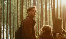 a man standing next to a young boy with a backpack