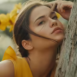 a woman in yellow with hair flying around