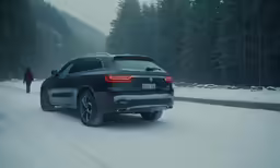 two people are walking down a snow - covered road