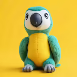 a stuffed animal sitting on a yellow background