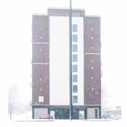 a white building surrounded by snow near an apartment building