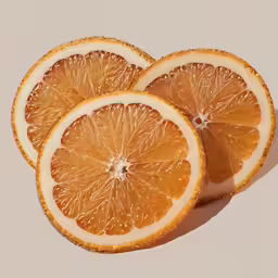 three orange slices on a brown surface