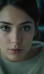 a woman looks into the camera with blue eyes