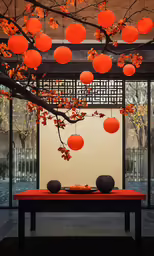 two orange lanterns sitting on a table