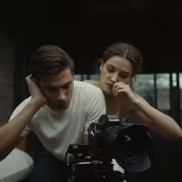 man and woman looking into camera at one another