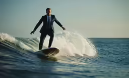 a man in a suit riding a surfboard