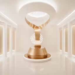a long hallway with golden sculptures sitting in the middle