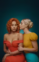 two ladies in short red and yellow dresses, one of which is wearing a blue and orange dress