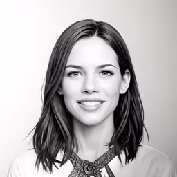 a close up of a person wearing a shirt and tie