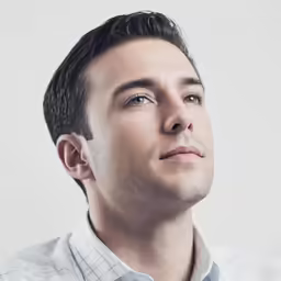 the man in a shirt and tie poses for the camera