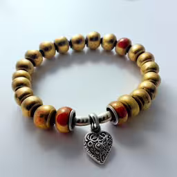 the bracelet has a heart and two different beads,a bead bracelet with a heart charm