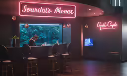 the neon sign reads, this is a cafe