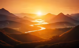 the sun setting over some hills and water