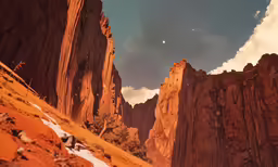 mountains near some rocks under a sky with clouds