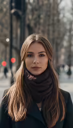 a woman is posing on the street in her scarf