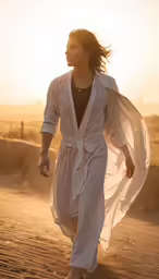 a woman in white attire with long hair, walking in the sand