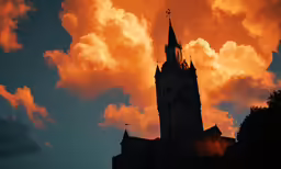 sunset over large building with clouds above and spires