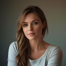 the young woman is posing for her portrait