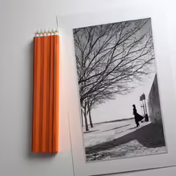 an open page of a notebook with a pencil next to it