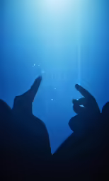 the person is touching his fingers and making a face