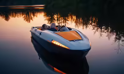 two people ride in the back of a speed boat